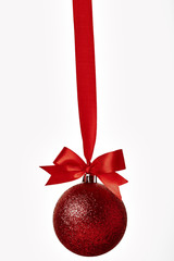 Red christmas ball with red bow over white