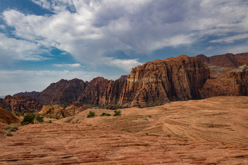 The Petrified sand dunes and amazing red Navajo sandstone mountains of Snow Canyon State Park in Southern Utah.