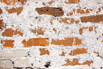 a wall of different colors bricks covered with lime