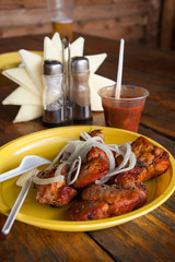 pieces of fried meat with pieces of onions on a plastic plate