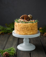 A beautiful chocolate, honey, ginger, spicy cake with Christmas decorations on a dark wooden holiday background. Perfect Xmas baked goods that you want to eat!)