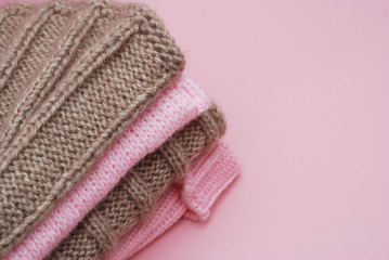 Pink and Brown Knitted Scarf on Pink Background with copy space for text. Winter Concept.