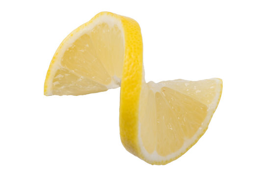 a slice of lemon cut and with a twisted, white background