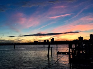 Fototapeta na wymiar Silhouette city and dock on Hudson River with sunset sky