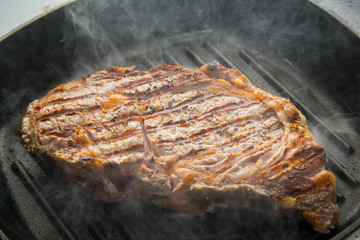 rib eye steak on grill pan
