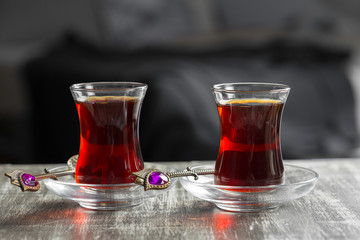 Red tea in turkish glasses on a wooden table