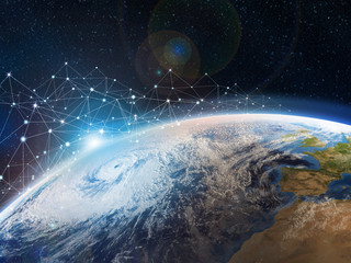 A view from outer space to Earth. The concept of data transmission and storage in the clouds. The Internet covers the planet. Hurricane over the ocean. Elements of this image furnished by NASA © Siarhei