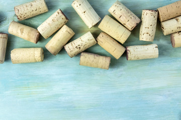 Vintage corks and corkscrew on teal with copy space