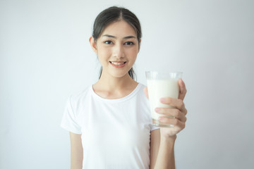 Young Asian Woman holding milk with smile on white background.