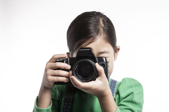 girl(kid) hand hold a camera isolated on the white background.
