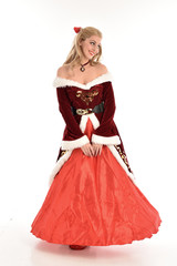 full length portrait of pretty blonde lady wearing red and white christmas inspired costume gown,...