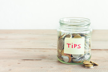 Coins in jar with Tips label