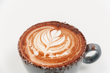 Close up coffee cup of rosetta latte art on white background isolated. Latte, cappuccino, cacao, hot chocolate.