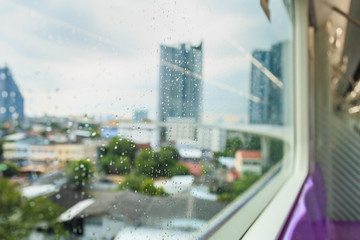 Raining drops on glass window of skytrain.