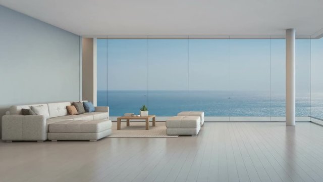 Large sofa on wooden floor near glass window with ocean and sky background at penthouse apartment, Lounge in sea view living room of modern luxury beach house or hotel - Home interior 3d illustration