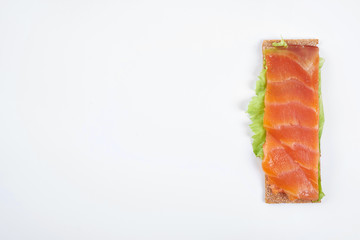 Low caloric open sandwich with red fish. Isolated on white background