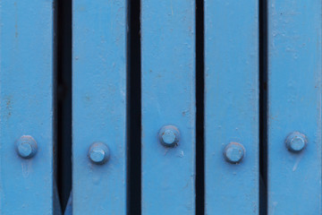 Close up old blue iron folding door at store front. Vintage background. Architecture detail.