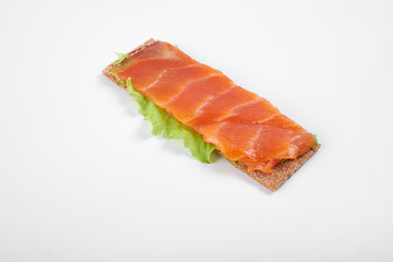 Low caloric open sandwich with red fish. Isolated on white background