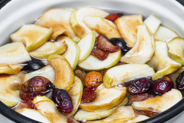 Preparationg of compote with dry apples, dogrose and strawberry. Selective focus