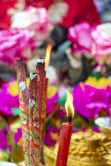incense burner incense stick joss sticks with fire.Burning red candle.