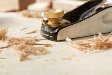 DIY concept. Woodworking and crafts. Chisel. plane and stock on the workbench. Top view. Wooden background.