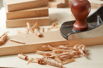 DIY concept. Woodworking and crafts. Chisel. plane and stock on the workbench. Top view. Wooden background.