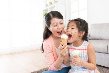 mother with daughter eating ice cream together