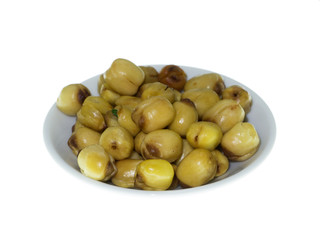 Lotus seeds roasted on white background.