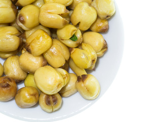Lotus seeds roasted on white background.