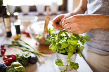 Unrecognizable young man cooking.