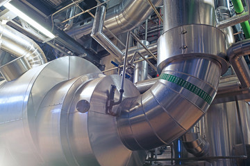 Equipment, cables and piping as found inside of a modern industrial power plant