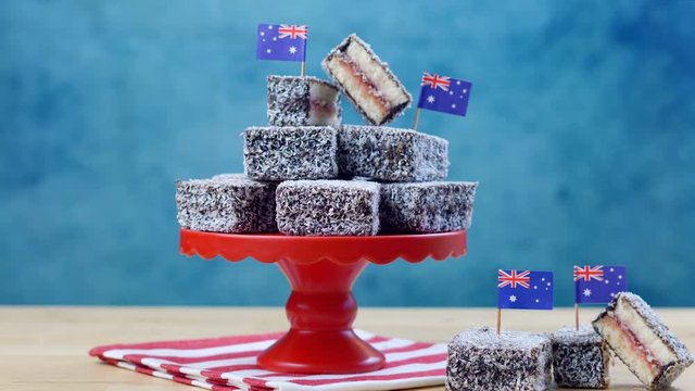 Iconic traditional Australian party food, Lamington cake, on a red, white and blue background.