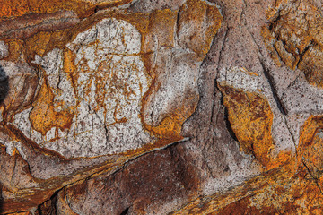 a colourful, jagge, stone background ove a rock cliff