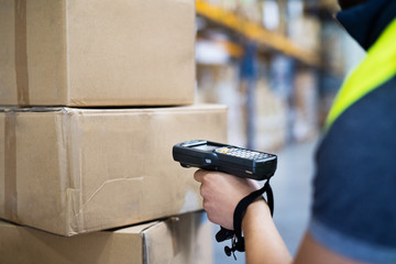 Male warehouse worker with barcode scanner.