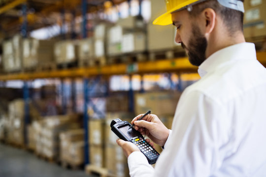 Warehouse worker or supervisor with barcode scanner.
