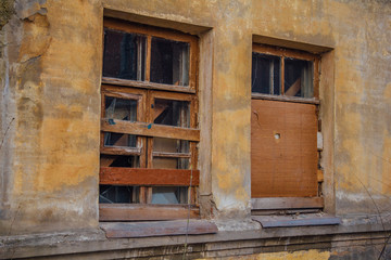 Boarded up windows of abandoned house