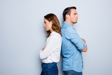 Portrait of unhappy frustrated couple standing back to back not speaking to each other after an...