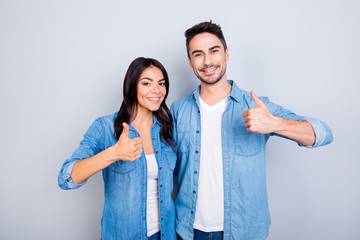 Sweet, attractive, smiling hispanic lovely cute couple in casual outfit showing  thumb up sign over...