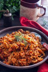 Traditional Polish bigos made from fresh and sour cabbage, selective focus