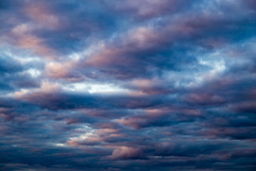 Naklejka na ściany i meble clouds in the sky at sunset as background