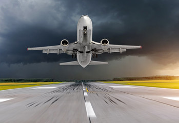 Fototapeta na wymiar Airplane take off at the airport in bad weather storm hurricane rain.