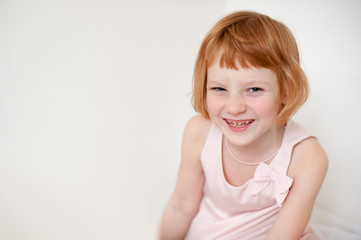 Portrait of a redhead smiling girl with dental caries with copyspace