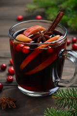 Christmas Mulled Wine with Apple and Cranberries. Holiday Concept Decorated with Fir Branches, Cranberries and Spices.