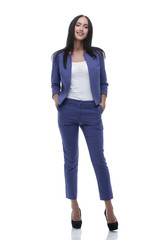 Confident young businesswoman standing with hands in pocket