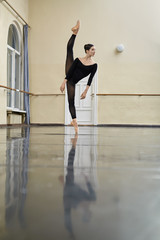 Fototapeta na wymiar Ballerina posing in dance hall