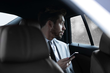 Handsome business man in car.