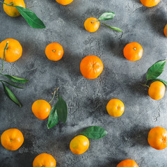 Citrus fruits pattern made of orange with leaves on dark background. Flat lay. Top view