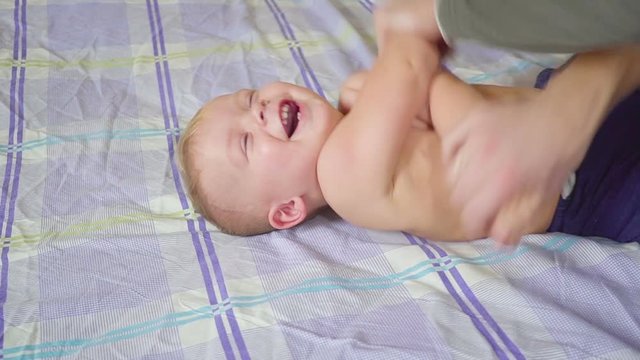 Father with his son doing special gymnastic exercises. Healthy lifestyle. Slow motion