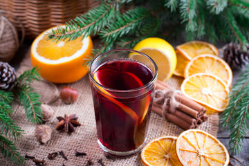Christmas hot mulled wine with cinnamon cardamom and anise on wooden background