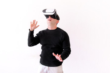 Handsome man wearing and playing virtual reality on isolated white background. Boy action in virtual reality helmet. VR glasses. VR Box, VR headset. Young business man at office and using Vr Box.